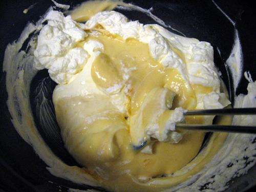 Add warmed egg yolks to hot maple syrup