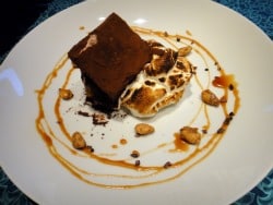 Plate with the torched meringue and drizzled caramel sauce