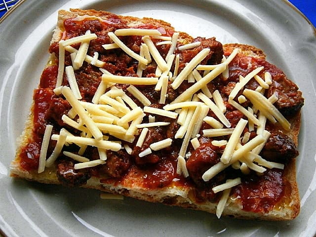Unbaked frozen pizza base with toppings