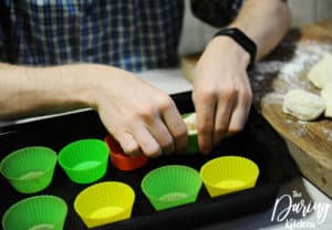Flatten each ball and press them into small muffin tins