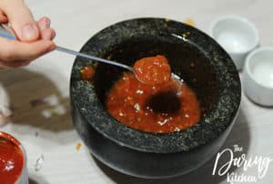 Grind the Pelati tomatoes garlic and spices with a mortar and pestle until mixture is a sauce-like consistency