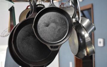 Cast iron skillets handing in a kitchen