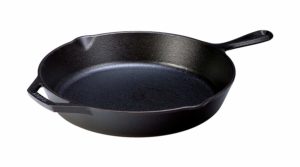 The Lodge Cast Iron 12-Inch Skillet is pictured over a field of white