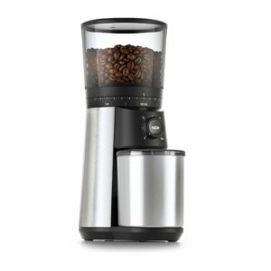 The OXO BREW Conical Burr Coffee Grinder is pictured over a field of white