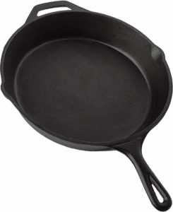 The Utopia Kitchen Pre-Seasoned Cast Iron Skillet is pictured over a field of white