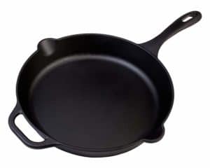 The Victoria 12 Inch Cast Iron Skillet is pictured over a field of white
