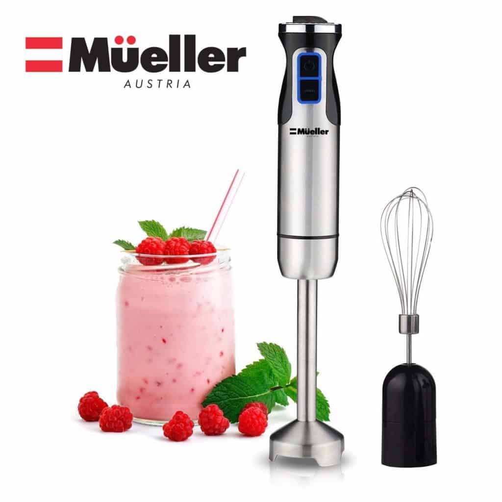 The Mueller Austria Ultra-Stick 500 Watt 9-Speed Immersion Multi-Purpose Hand Blender is pictured beside a smoothie and a whisk attachment 