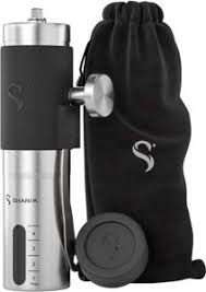 The Shanik Premium Quality Stainless Steel Manual Coffee Grinder i s pictured beside its carrying bag