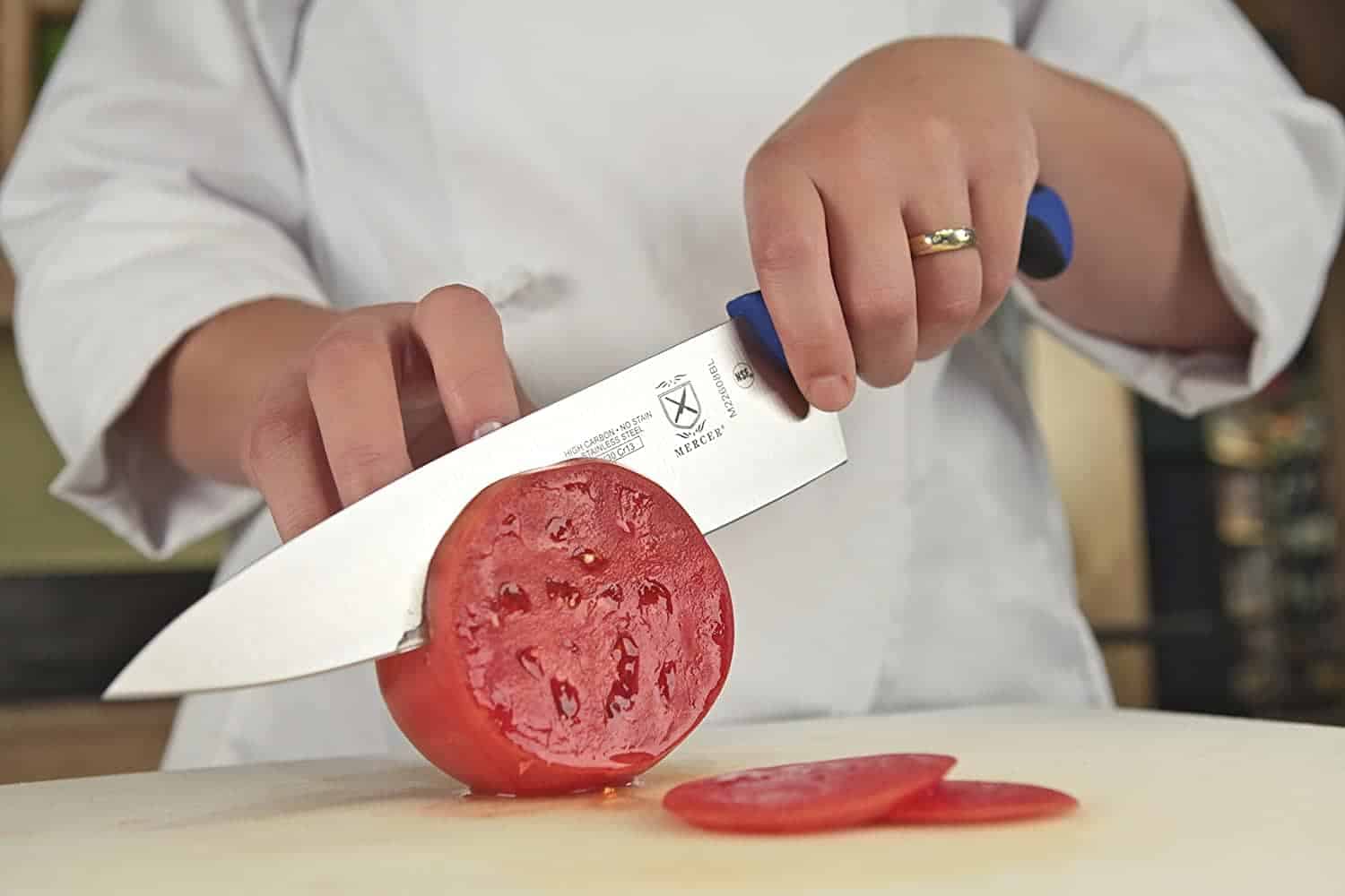 Chopping tomato with chef knife
