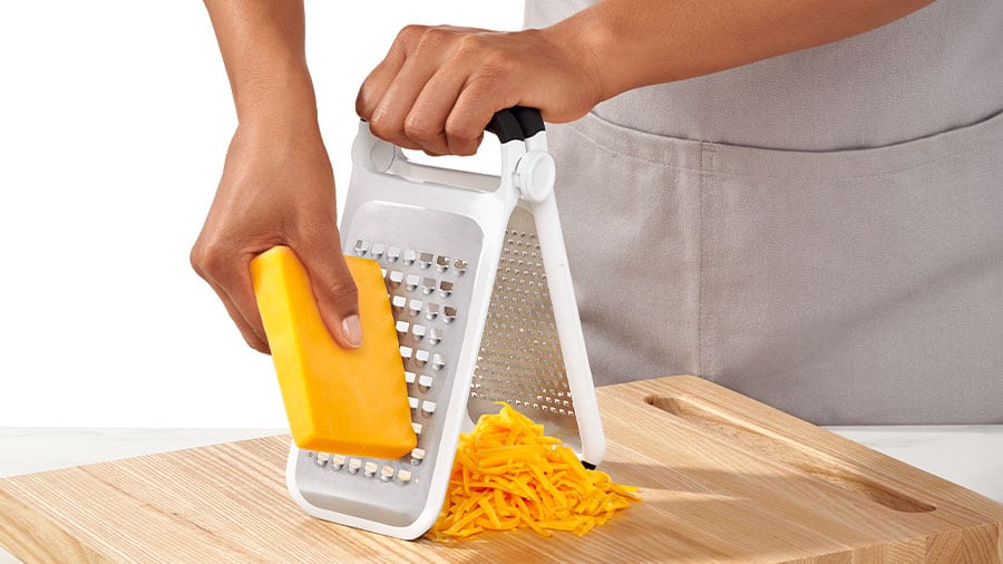 Shredding cheese with a box cheese grater