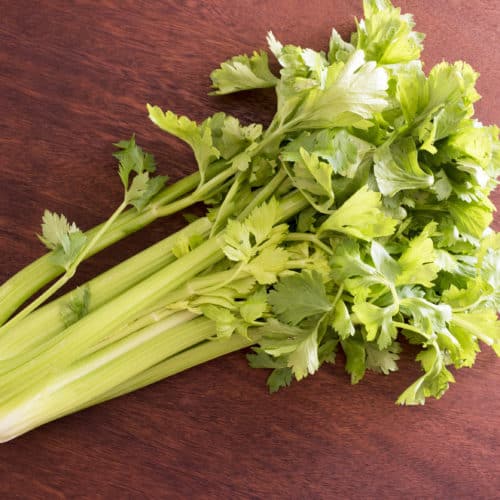 A bunch of celery on brown surface