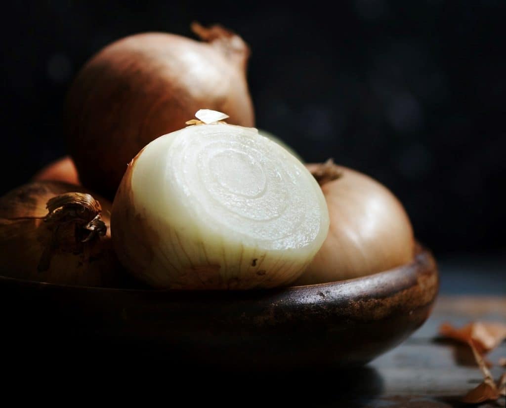 Onions in wooden bowl