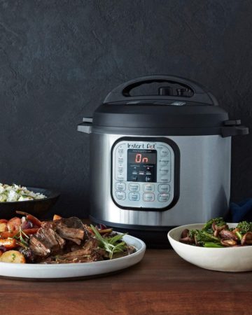 Pressure cooker alongside various dishes