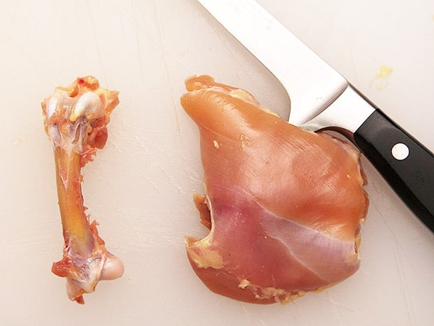 Removing bone from meat with a boning knife