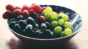 green red and black grapes in a bowl. 