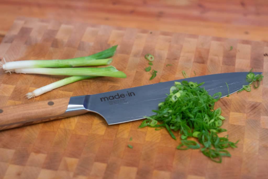 https://static.thedaringkitchen.com/wp-content/uploads/2021/08/made-in-chefs-knife-scallions-1024x683.jpg